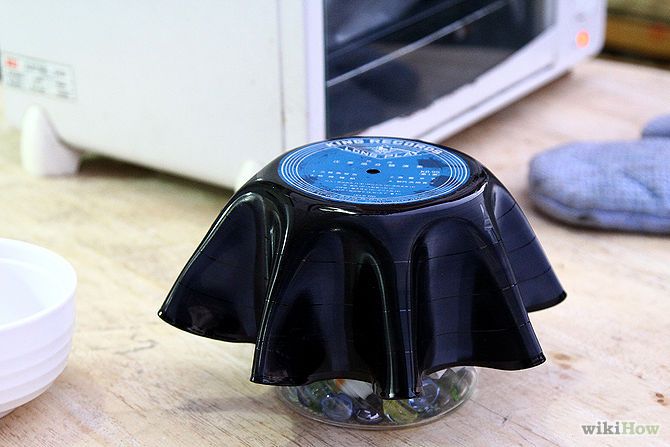 a microwave oven sitting on top of a wooden table next to a blue and black object