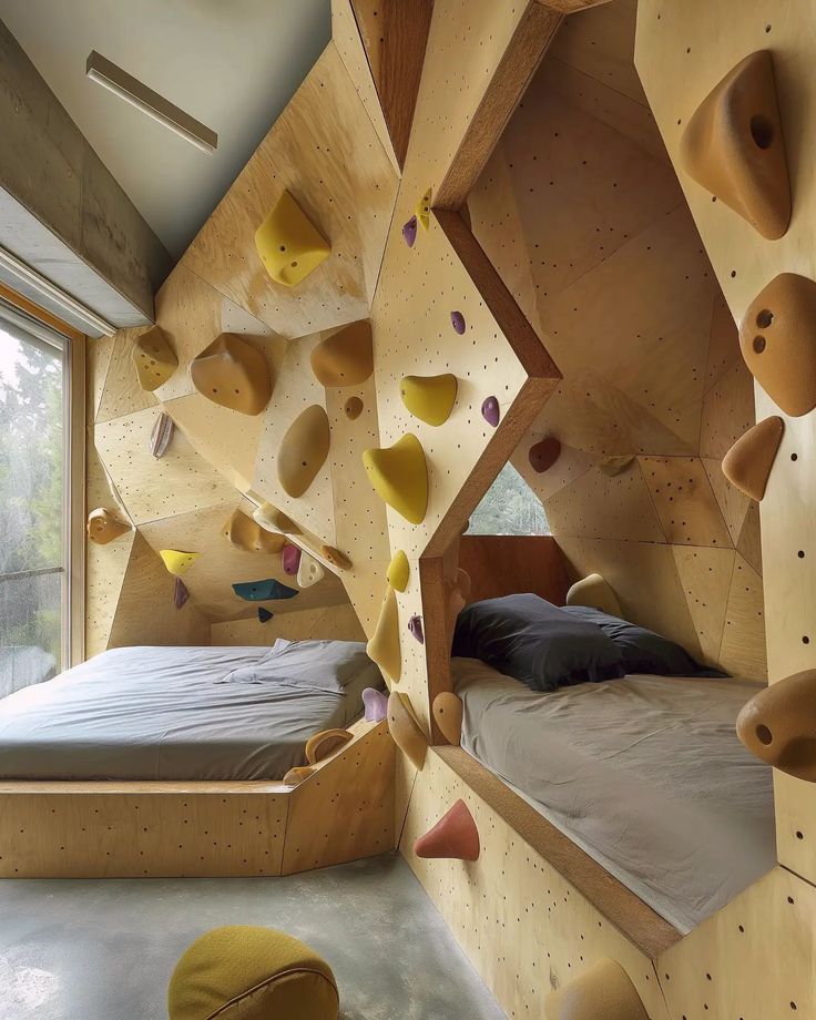 a bedroom with climbing walls and bed in the middle is made out of plywood