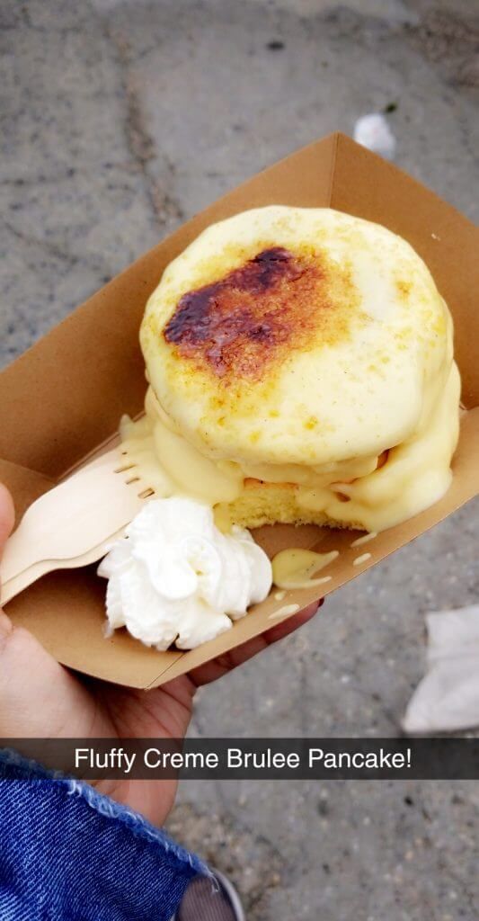 a person holding a plate with some food on it and the words fluffy creme brulee pancakes