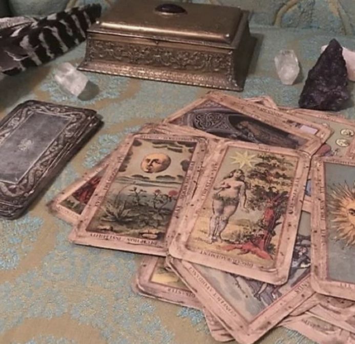 there are many cards on the table and one is in front of a small box