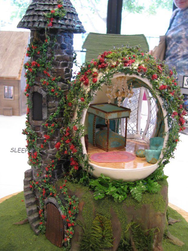 a doll house made to look like a fairy garden