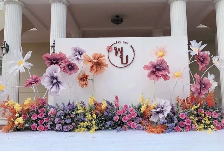 flowers are arranged on the side of a building