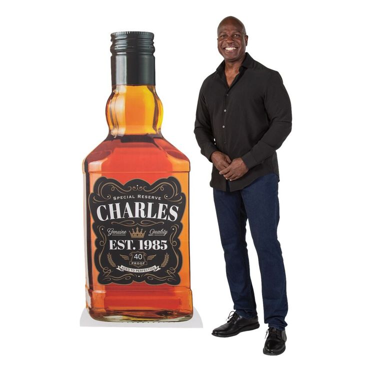 a man standing next to a bottle of charles's whiskey on a white background