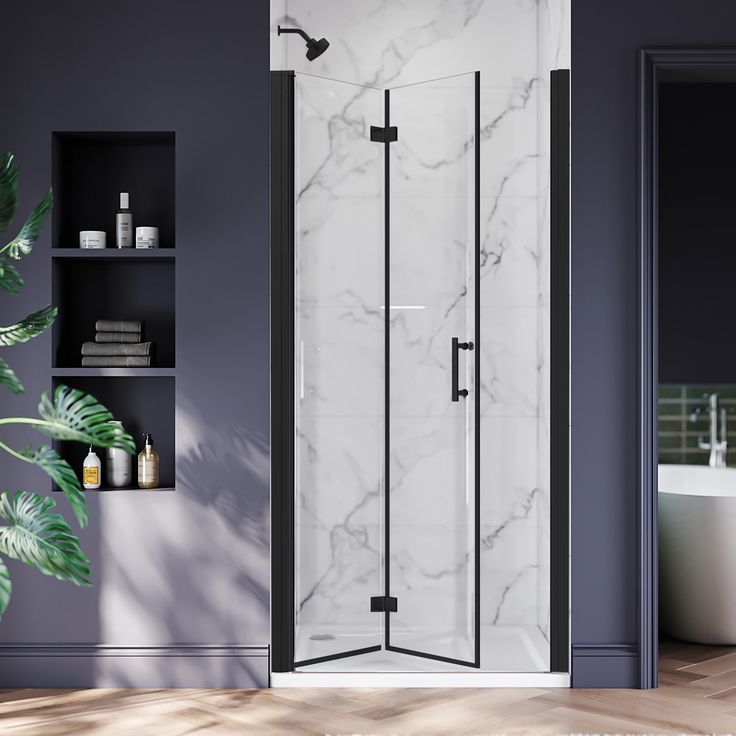 a white and black bathroom with a stand up shower next to a bathtub in the corner