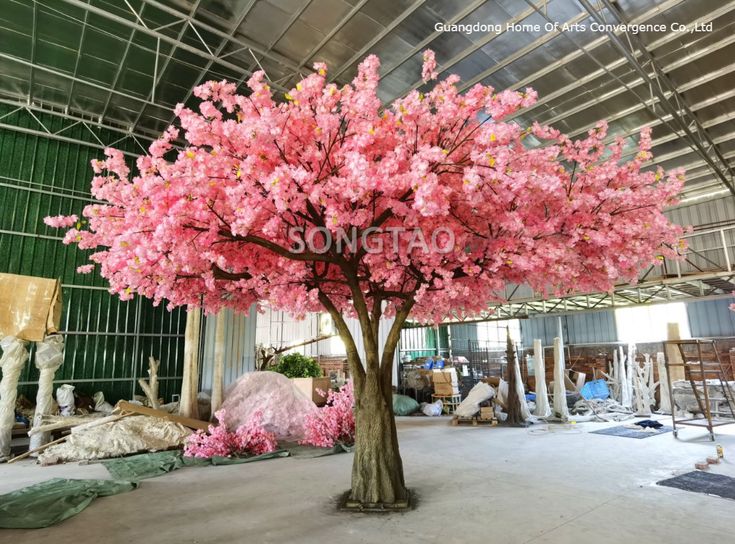 a pink tree in the middle of a large room