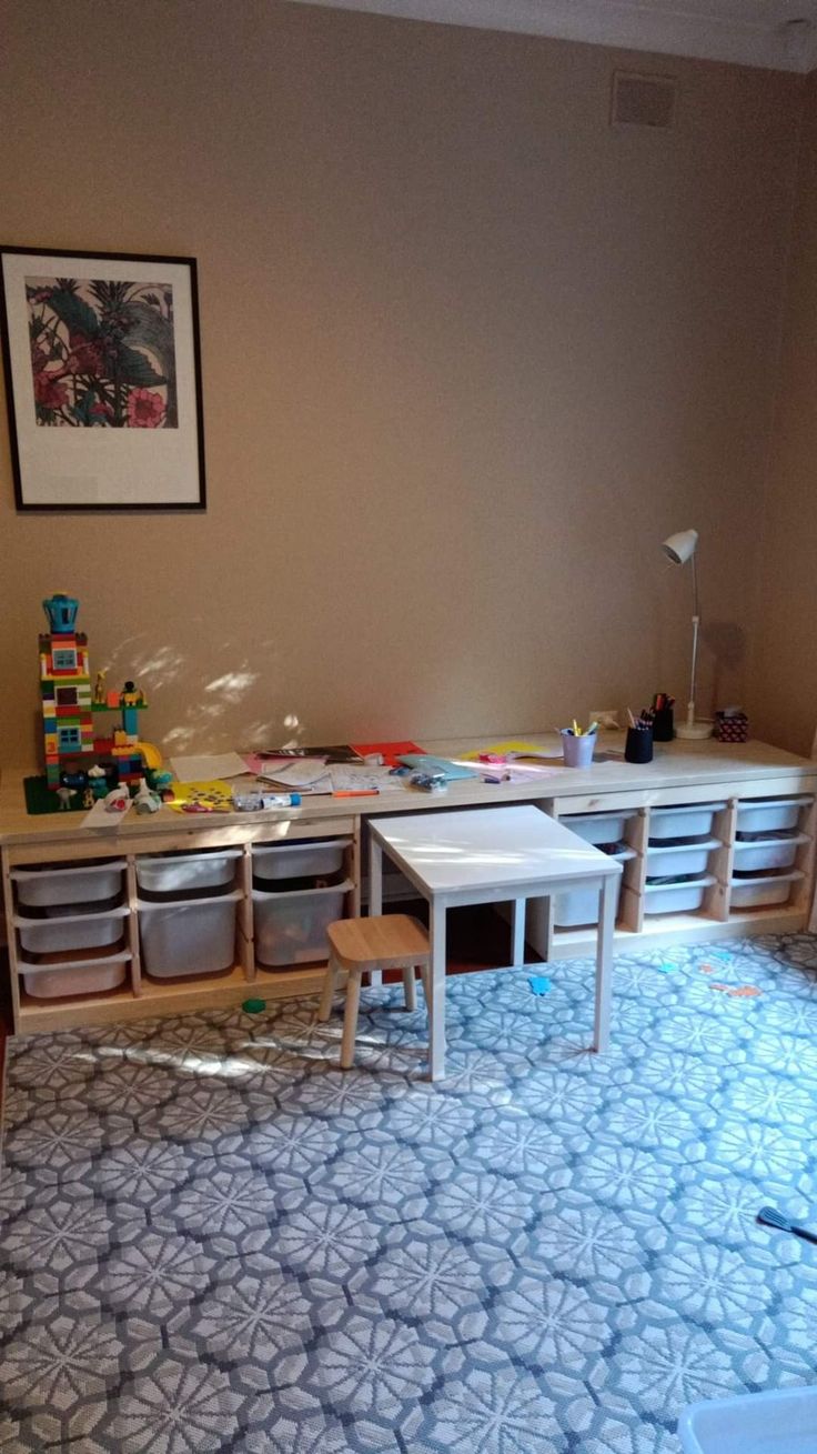 an empty room with toys on the floor and other items in bins next to it