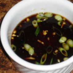 a white bowl filled with soup sitting on top of a counter