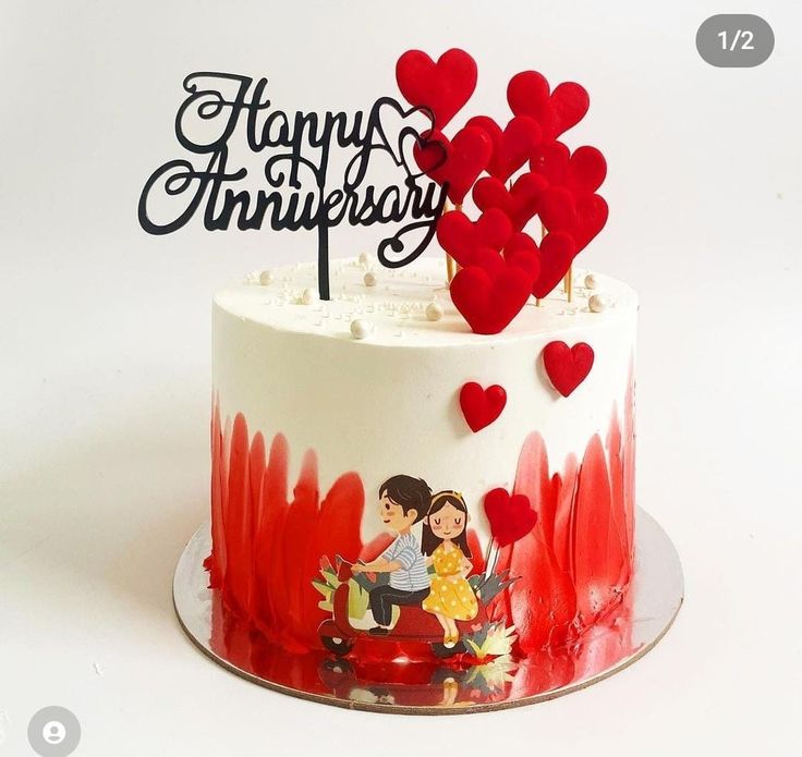 a white cake with red frosting and hearts on top that reads, happy anniversary