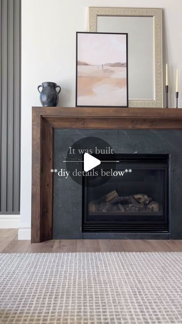 a living room with a fireplace and pictures on the wall