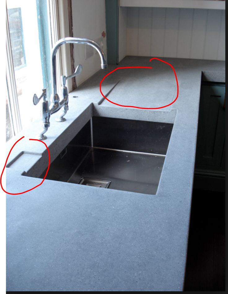 two red circles are shown in the middle of a kitchen sink with no faucet