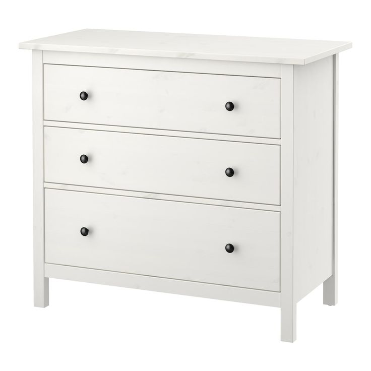 a white dresser with three drawers and two doors on the bottom drawer, against a white background