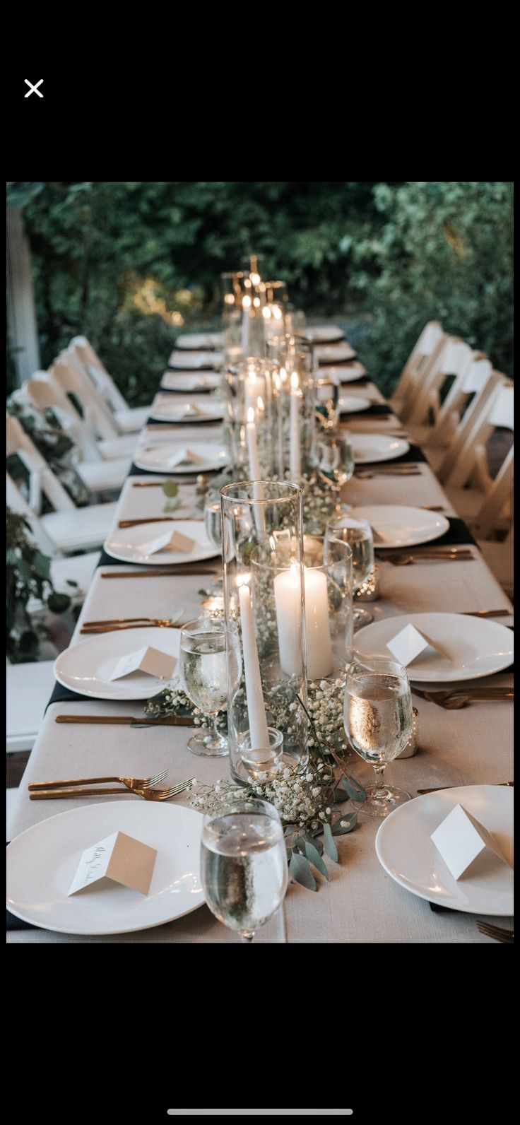 the table is set with candles and place settings