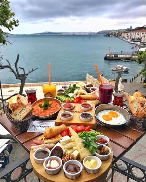 an image of a table with food on it and water in the backround