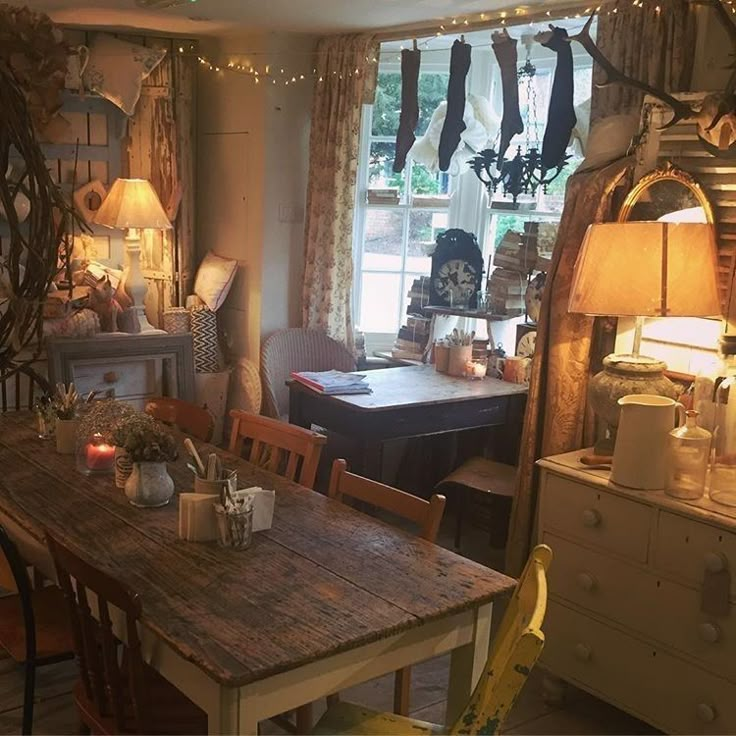 a dining room filled with lots of furniture and lights on top of it's windows