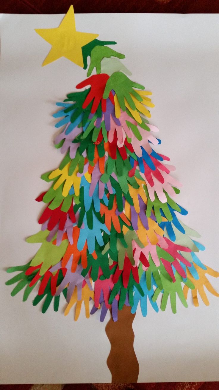 a paper christmas tree made out of colored handprints