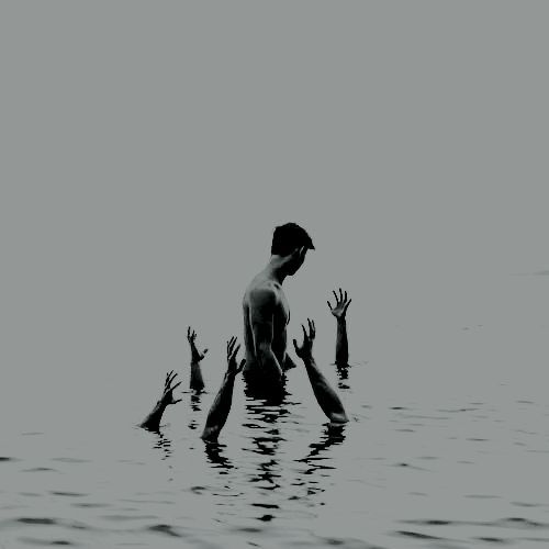 several people reaching up into the water to catch a frisbee with their hands