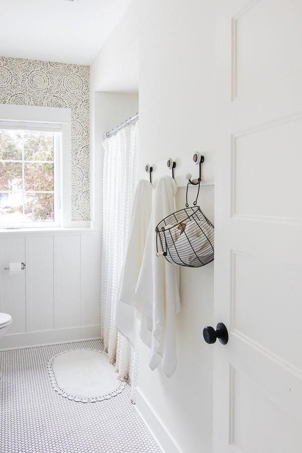 a bathroom with white walls and black accents