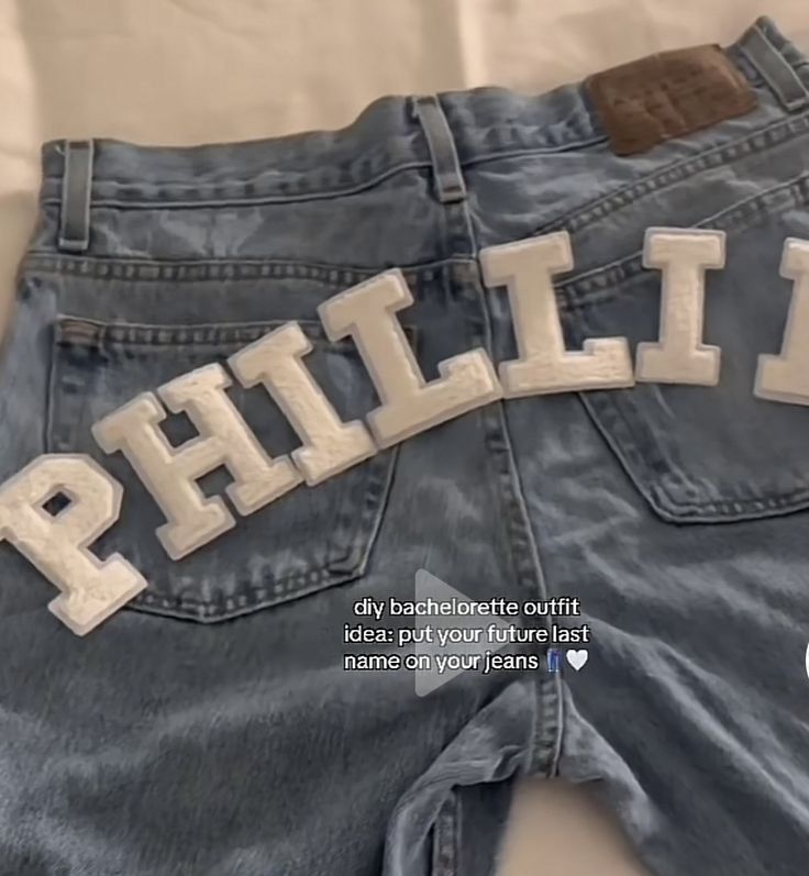 a pair of blue jean shorts with the word philii printed on it's back