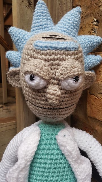 a crocheted stuffed toy with an ugly expression on it's face and eyes