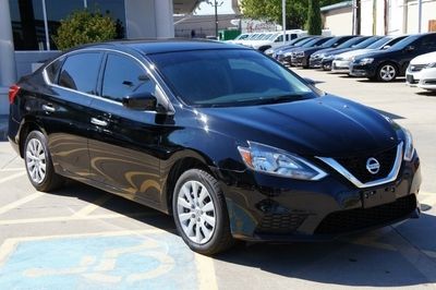 a black car is parked in a parking lot