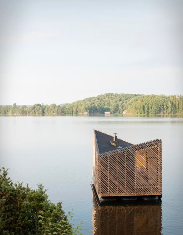 a wooden structure sitting on top of a lake