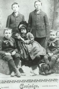 an old black and white photo of four children