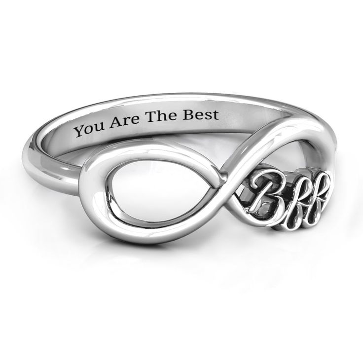 a silver ring with the word love and an intertwined heart on it's side