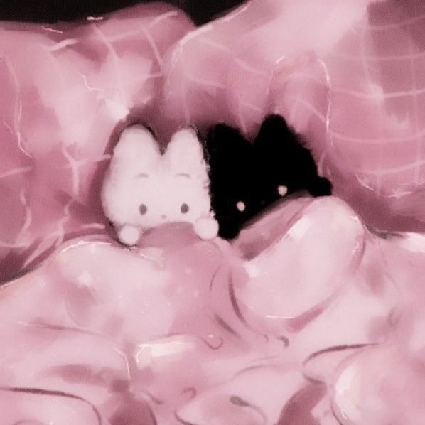 a hello kitty stuffed animal sitting on top of a pink blanket