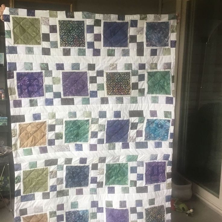 a large quilt is hanging on the wall