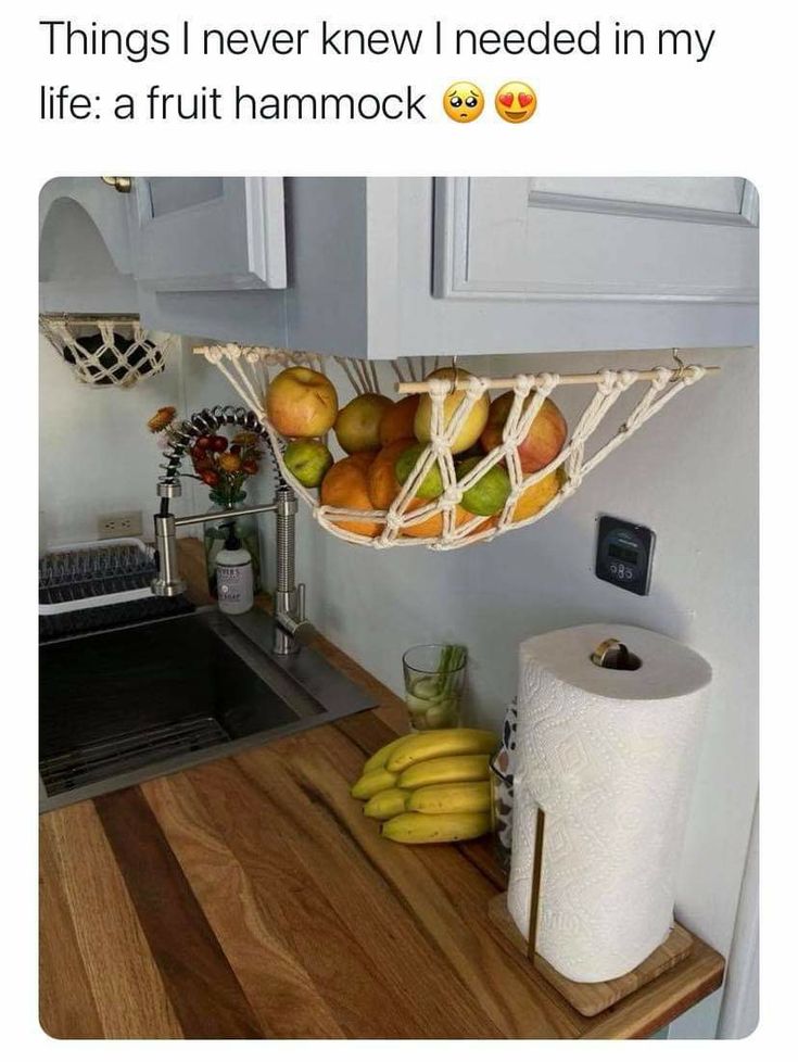 there is a hanging fruit basket in the kitchen