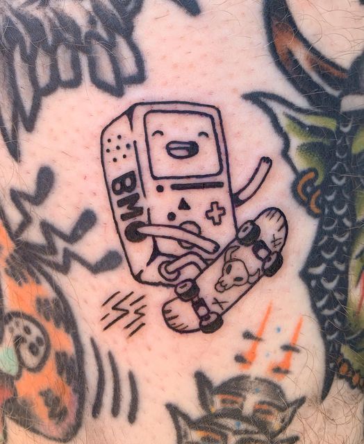 a man with a tattoo on his chest has a drawing of a video game controller