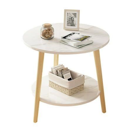 a white table with some books on top of it and a basket next to it