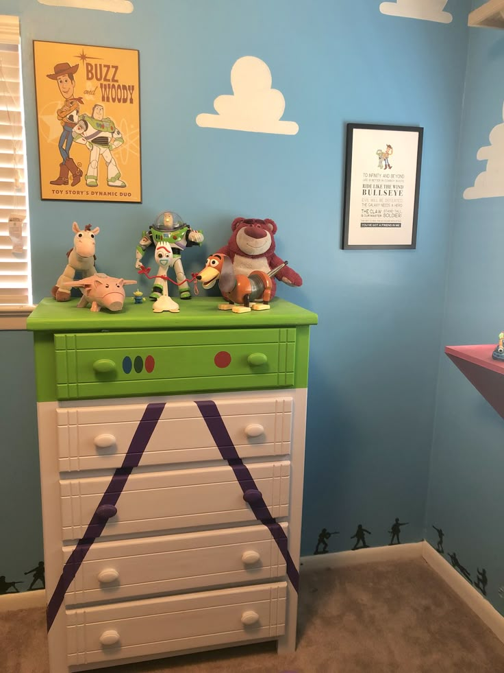 a green and white dresser in a child's room with toy animals on top