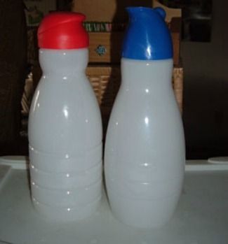 two plastic bottles sitting on top of a table