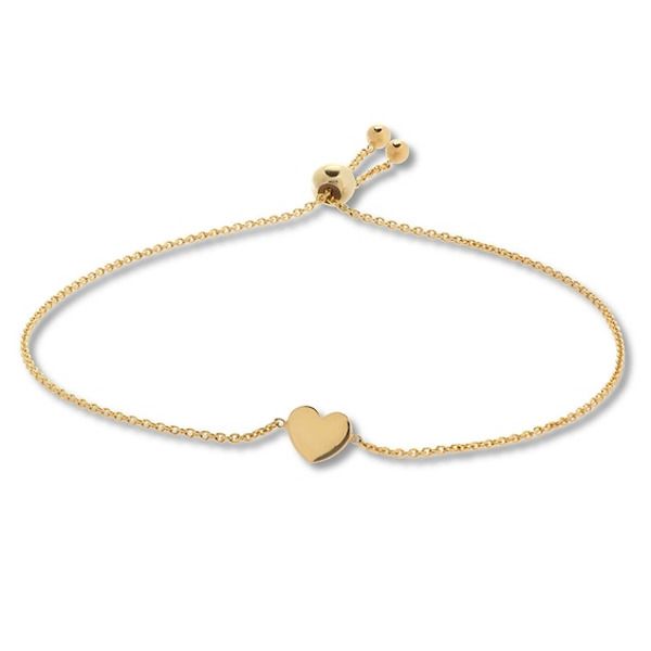 This charming bolo bracelet for her features a 14K yellow gold heart. The bracelet adjusts with the sliding bolo clasp. Adjustable Yellow Gold Heart Bracelet For Anniversary, Adjustable Yellow Gold Minimalist Heart Bracelet, Adjustable Minimalist Yellow Gold Heart Bracelet, Classic Adjustable Heart Bracelet For Valentine's Day, Adjustable Classic Heart Bracelet For Valentine's Day, Gold Heart-shaped Jewelry With Adjustable Length, Adjustable Length Heart-shaped Gold Jewelry, Adjustable 14k Yellow Gold Heart Bracelet, Classic Yellow Gold Adjustable Heart Bracelet