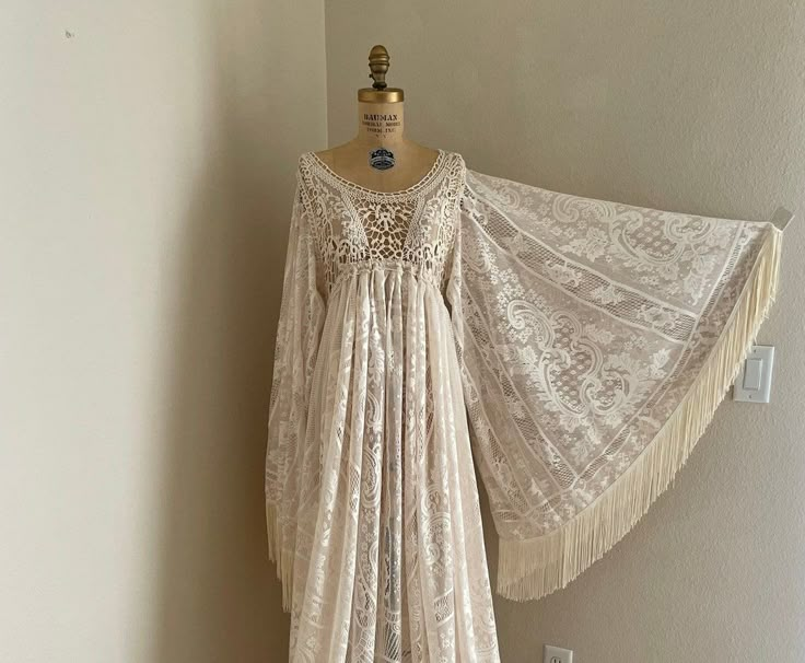 a white dress hanging on a wall