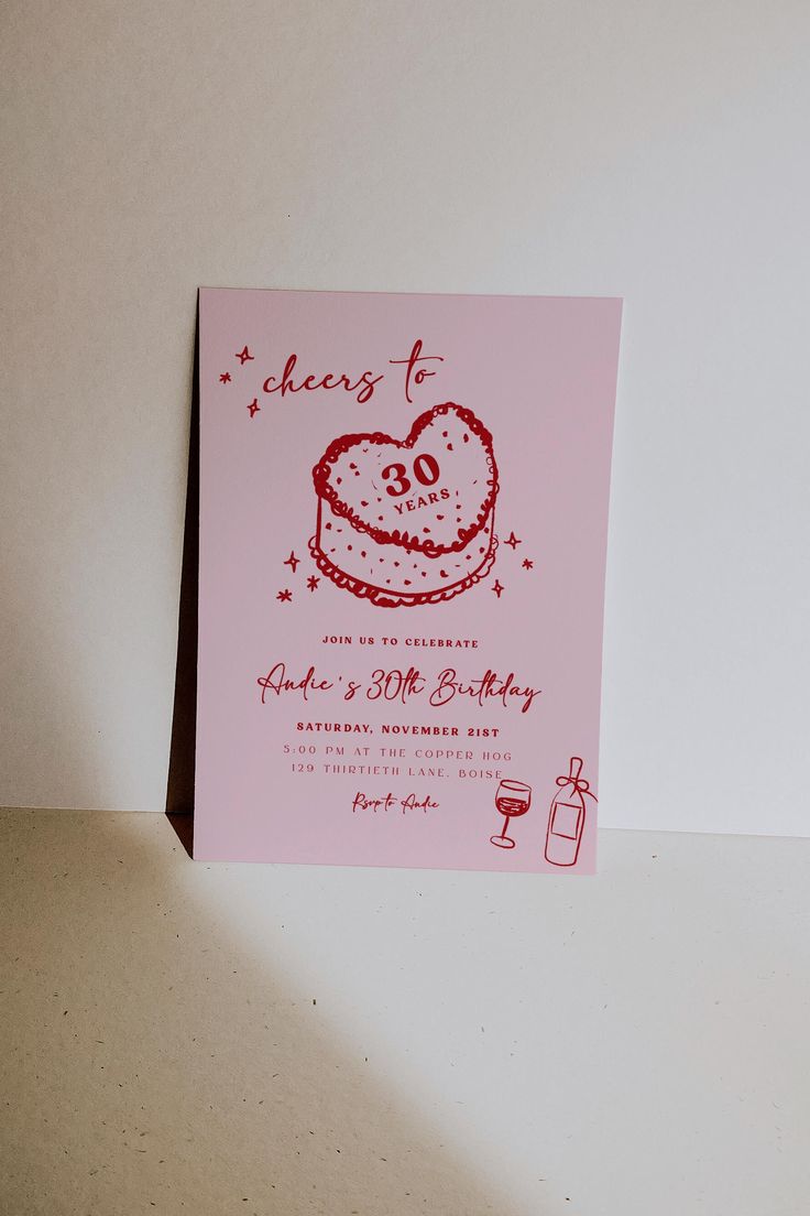 a pink card with a heart shaped cake on it