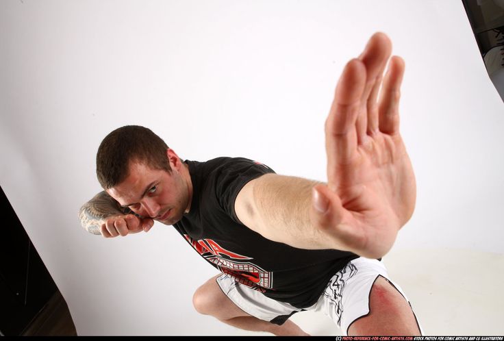 a man in black shirt and white shorts doing a kick