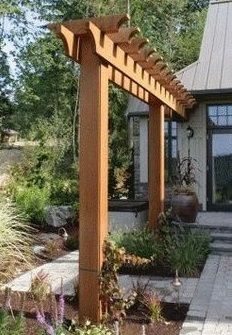 an outdoor patio with wooden pergols and flowers