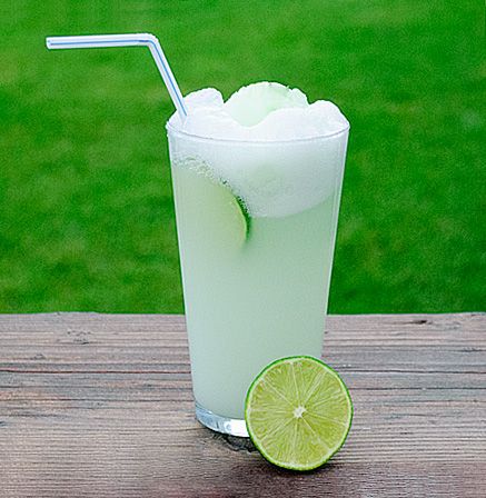 a limeade drink on a wooden table outside