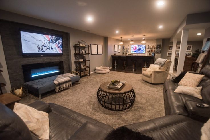 a living room filled with furniture and a flat screen tv mounted to the side of a wall