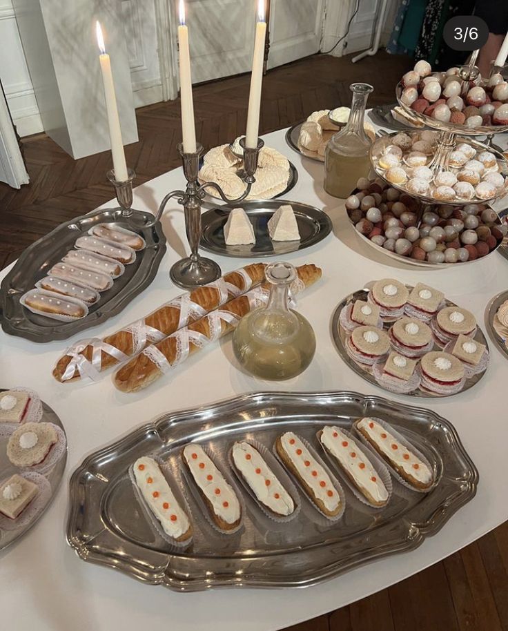 a table topped with lots of food and candles