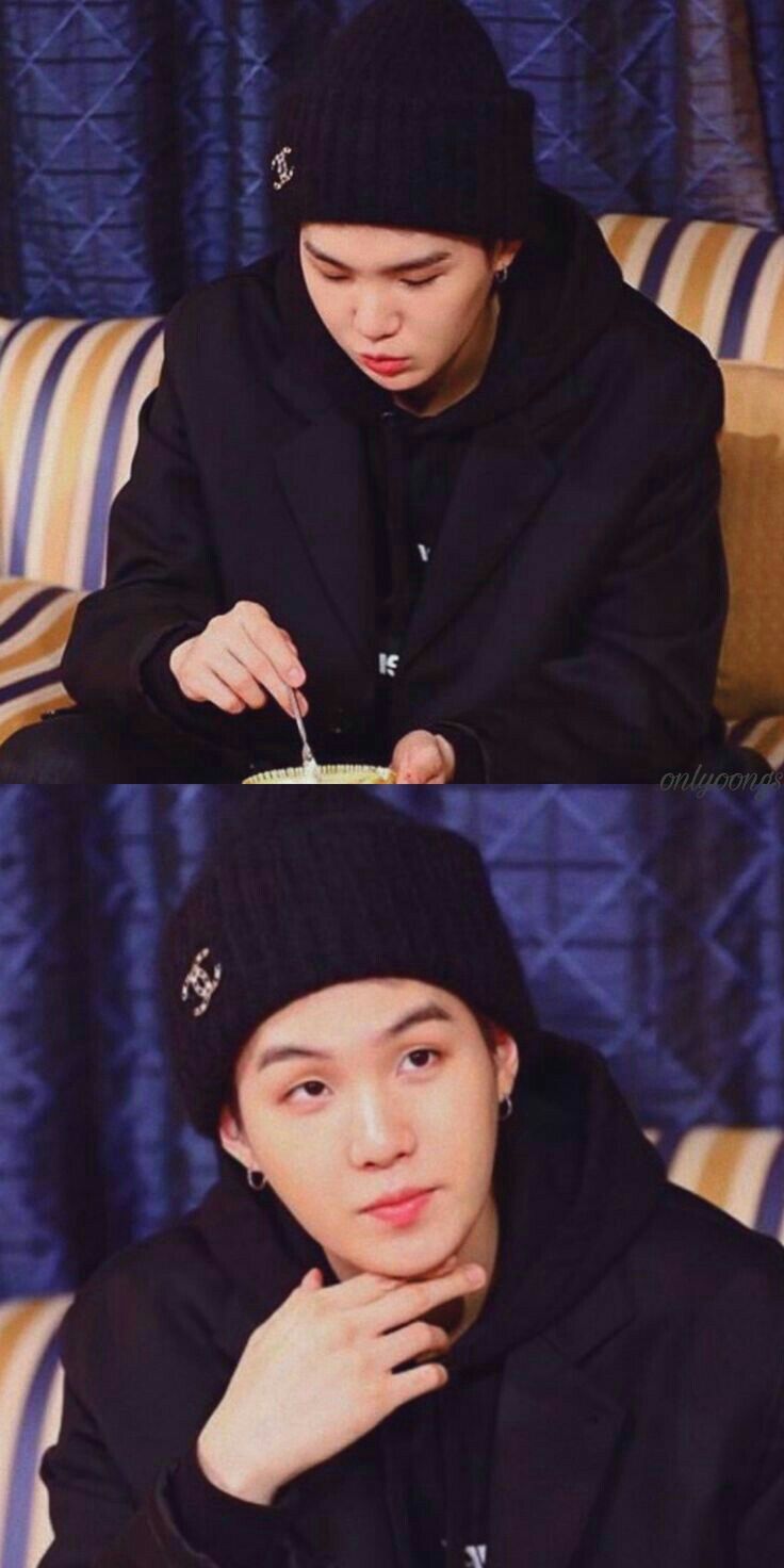 a man sitting on top of a couch wearing a beanie