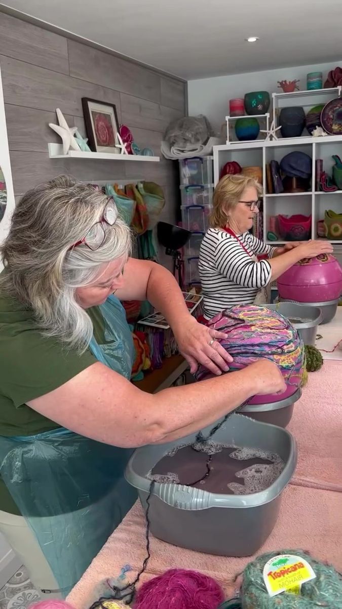 two women working on crafts in a room