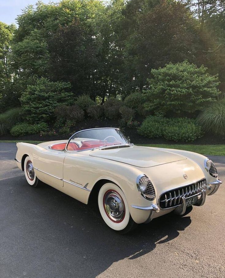 an old car is parked in the parking lot