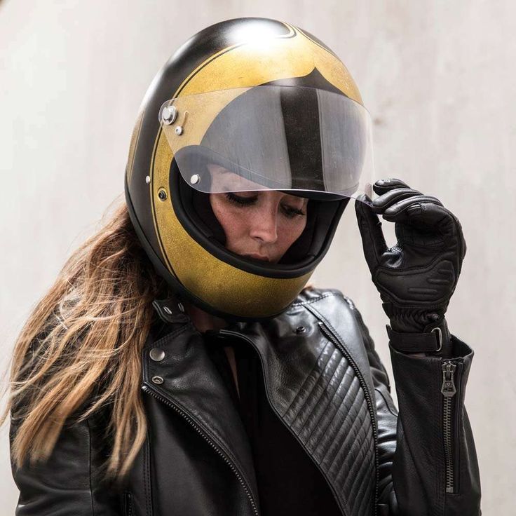 a woman wearing a yellow and black motorcycle helmet