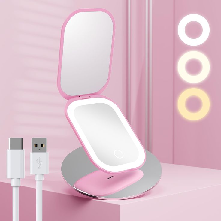 an electronic device with a mirror on top of it next to a charger plugged in