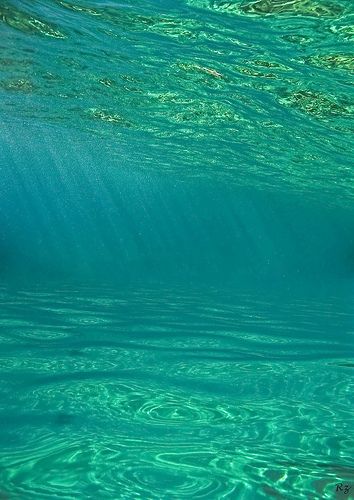 a man riding a wave on top of a surfboard in the ocean under water