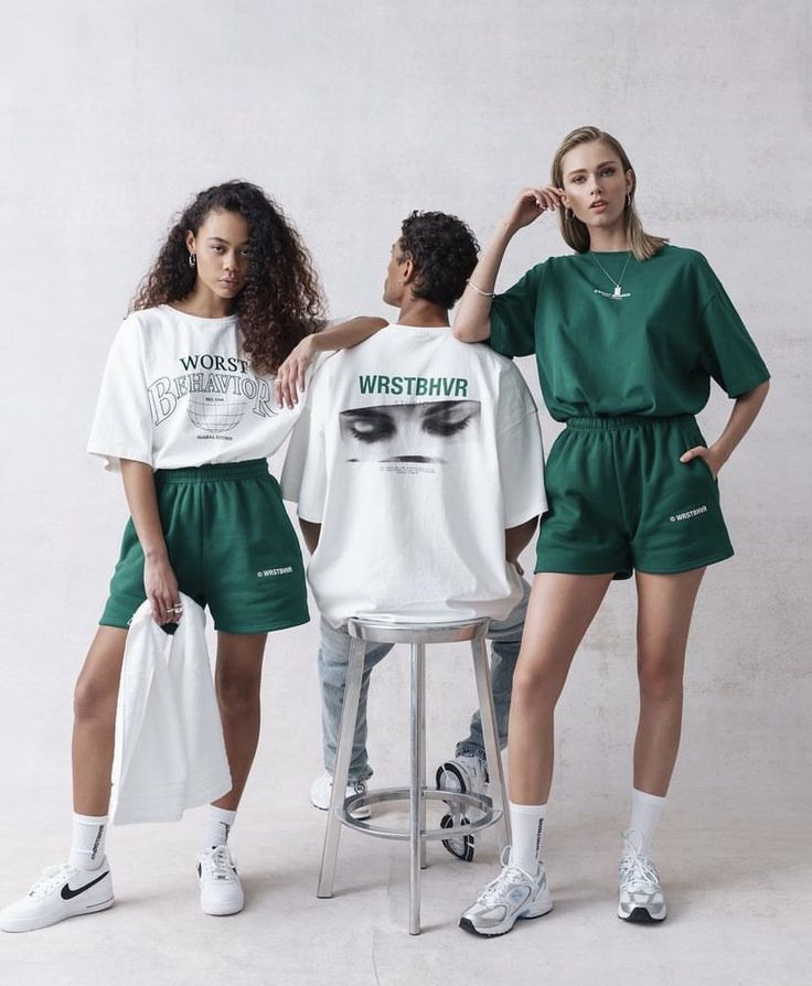 three models in green shorts and white t - shirts standing next to each other with their hands on their hips