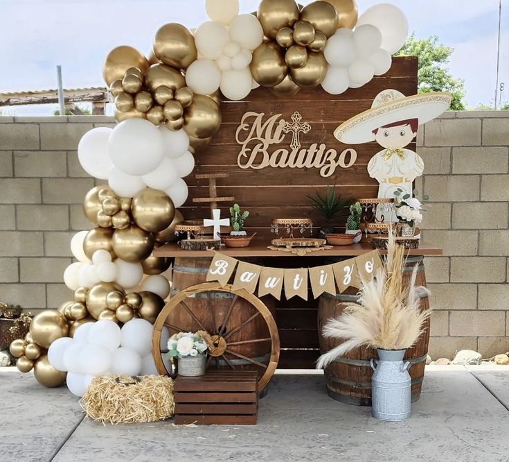 a table topped with balloons and other items in front of a sign that says mr & mrs babatgo